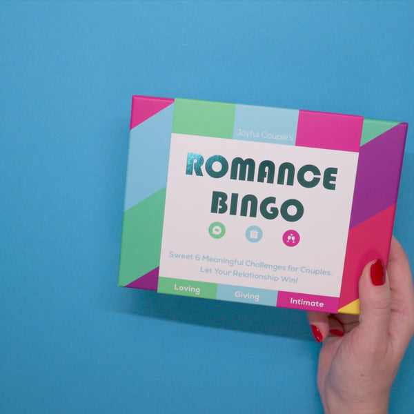 woman holding in her hands and swirling the romance bingo by joyful couple, blue background, short video